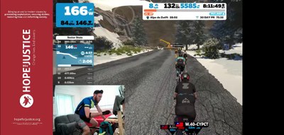 Curate’s Crazy Cycling Concludes- Richard Saint cycling on Zwift and typing a reply