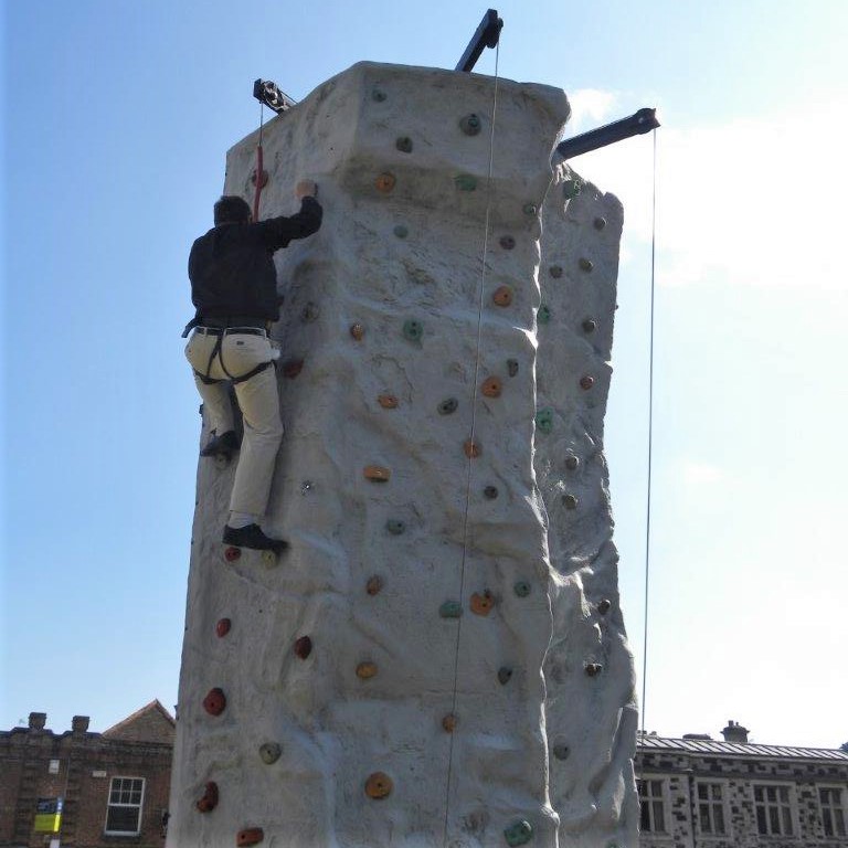 Fun Day raises over 3K- Wimborne Rector Andrew Rowland scales the climbing wall