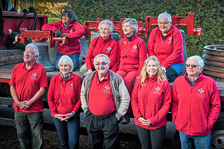 The bells are back in time for Christmas- ringers and lorry at Lychett Matravers