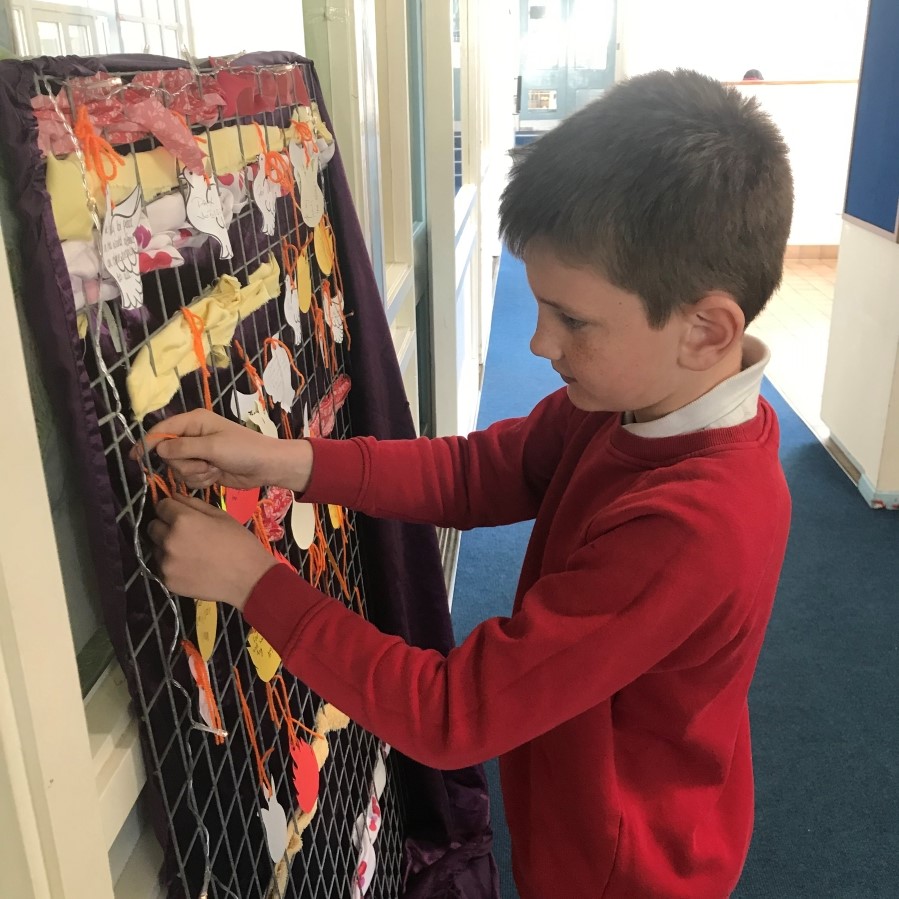 Weaving peace, prayer and Pentecost together- boy weaves artwork at Easterton School