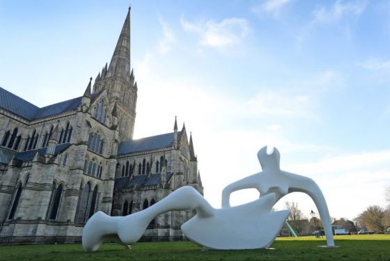 Large reclining figure and sitting couple on a bench