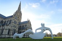 Large reclining figure and sitting couple on a bench